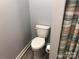 Small bathroom with toilet and shower curtain at 306 Union St, Maiden, NC 28650