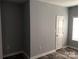 Bedroom with gray walls, wood-look floors, and a door at 306 Union St, Maiden, NC 28650