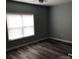 Simple bedroom with large window and wood-look floors at 306 Union St, Maiden, NC 28650