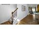 Elegant hardwood staircase with black metal railing in the foyer at 3719 13Th Ne St, Hickory, NC 28601