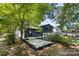 Private backyard with patio and mature trees at 3801 Woodleaf Rd, Charlotte, NC 28205