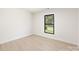 Bright bedroom with large window and light wood floors at 3801 Woodleaf Rd, Charlotte, NC 28205