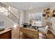 Dining area with wood floors, a black table, and a staircase visible in the background at 4119 Flint Dr, Lancaster, SC 29720