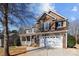 Two-story house with brown siding, white garage door, and landscaping at 4119 Flint Dr, Lancaster, SC 29720