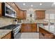 Kitchen features granite countertops, wood cabinets, and stainless steel appliances at 4119 Flint Dr, Lancaster, SC 29720