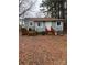 Back of house with wooden deck and pine straw ground cover at 415 Sherman St, Gastonia, NC 28052