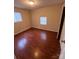 Spacious bedroom with wood-look floors and a window at 415 Sherman St, Gastonia, NC 28052