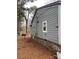 Side view of the house with stone accents and mature trees at 415 Sherman St, Gastonia, NC 28052