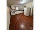 Simple kitchen featuring white cabinets and laminate floors at 415 Sherman St, Gastonia, NC 28052