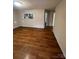 Open living area with wood-look floors and access to kitchen at 415 Sherman St, Gastonia, NC 28052