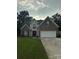 Brick two-story house with a large driveway and landscaped lawn at 4305 Chatterleigh Dr, Monroe, NC 28110