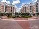 Luxury community with manicured landscaping, a central fountain, and attractive buildings at 4620 Piedmont Row Dr # 608, Charlotte, NC 28210