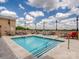 Communal rooftop pool with lounge chairs at 4620 Piedmont Row Dr # 608, Charlotte, NC 28210