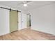 Bright bedroom with light hardwood floors and a barn door at 4804 Chapel Grove Rd, Gastonia, NC 28052