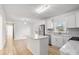 White kitchen cabinets, island, and light wood floors at 4804 Chapel Grove Rd, Gastonia, NC 28052