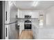 Renovated kitchen featuring stainless steel appliances and white cabinetry at 4804 Chapel Grove Rd, Gastonia, NC 28052