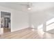 Living room with hardwood floors, ceiling fan, and kitchen view at 4804 Chapel Grove Rd, Gastonia, NC 28052