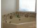 Relaxing bathroom with corner soaking tub and tile surround at 4819 Vander Ln # 54, Monroe, NC 28110