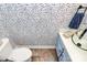 Stylish half-bathroom with patterned wallpaper, a vessel sink, and modern fixtures at 503 Bridgestone Ct, Gastonia, NC 28056