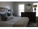 Spacious bedroom with dresser, neutral decor, and large windows at 503 Bridgestone Ct, Gastonia, NC 28056