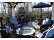 Relaxing deck with fire pit, seating, and umbrella at 503 Bridgestone Ct, Gastonia, NC 28056