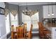 Kitchen dining area with wood table and chairs, and decorative window treatments at 503 Bridgestone Ct, Gastonia, NC 28056