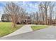 Traditional brick home featuring a large front yard and curved driveway at 503 Bridgestone Ct, Gastonia, NC 28056