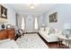 Bright living room with white sofa, patterned rug, and natural light from the large windows at 503 Bridgestone Ct, Gastonia, NC 28056