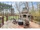 Cozy backyard deck featuring a stone fireplace and outdoor seating at 503 Bridgestone Ct, Gastonia, NC 28056