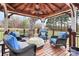 Covered pergola with comfortable seating and a wood ceiling fan at 503 Bridgestone Ct, Gastonia, NC 28056