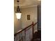 Wooden staircase with a light-colored railing and pendant lighting at 503 Bridgestone Ct, Gastonia, NC 28056