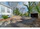 Gravel driveway, detached garage, and fenced backyard at 506 S Chester St, Gastonia, NC 28052