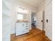 White bathroom with pedestal sink, clawfoot tub, and built-in shelving at 506 S Chester St, Gastonia, NC 28052