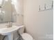 Clean bathroom with pedestal sink and shower at 506 S Chester St, Gastonia, NC 28052