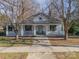 Charming white house with a wraparound porch and well-manicured lawn at 506 S Chester St, Gastonia, NC 28052