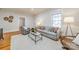 Cozy living room featuring hardwood floors, a comfortable sofa, and a large window at 506 S Chester St, Gastonia, NC 28052