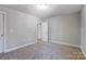 Bedroom with carpeted floor and access to hallway at 5107 Lakeview Rd, Charlotte, NC 28216