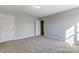 Spacious bedroom with carpeted floor and adjacent bathroom at 5107 Lakeview Rd, Charlotte, NC 28216