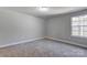 Bright bedroom with carpet flooring and a large window at 5107 Lakeview Rd, Charlotte, NC 28216