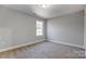 Well-lit bedroom with carpeted floors and a window at 5107 Lakeview Rd, Charlotte, NC 28216