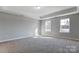 Bright bedroom with neutral walls and carpet flooring at 5107 Lakeview Rd, Charlotte, NC 28216