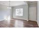 Simple dining room with hardwood floors and large window at 5107 Lakeview Rd, Charlotte, NC 28216