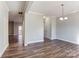 Simple dining room with hardwood floors and access to kitchen and living room at 5107 Lakeview Rd, Charlotte, NC 28216