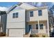 Two-story home with light blue and beige siding, brick accents, and a two-car garage at 5107 Lakeview Rd, Charlotte, NC 28216