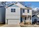 Two-story home with light blue and beige siding, brick accents, and a two-car garage at 5107 Lakeview Rd, Charlotte, NC 28216