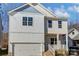 Two-story home with light blue and beige siding, brick accents, and a two-car garage at 5107 Lakeview Rd, Charlotte, NC 28216