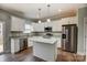 Modern kitchen with white cabinets, granite countertops, and stainless steel appliances at 5107 Lakeview Rd, Charlotte, NC 28216