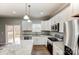 Modern kitchen with stainless steel appliances and granite countertops, deck access at 5107 Lakeview Rd, Charlotte, NC 28216