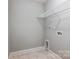 Laundry room with shelving and hexagonal tile flooring at 5107 Lakeview Rd, Charlotte, NC 28216