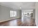 Open living room with hardwood floors, kitchen and staircase views at 5107 Lakeview Rd, Charlotte, NC 28216